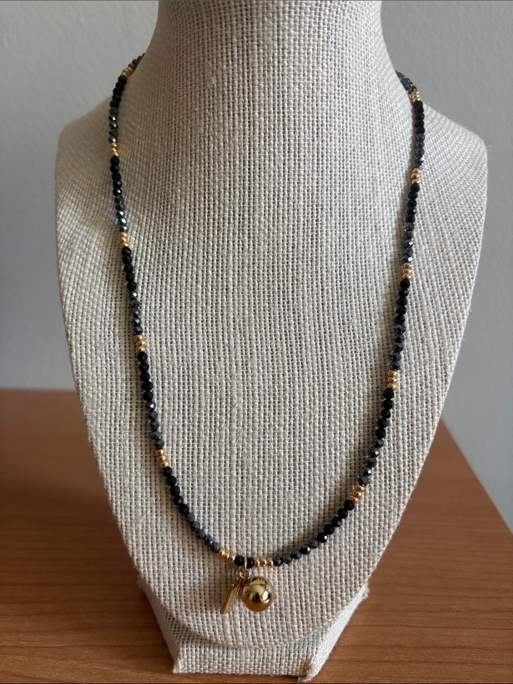 Black Beaded Necklace with Gold Accents and Charm